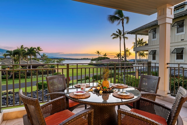 69-1000 Kolea Kai Cir Unit 7E, Waikoloa, HI 96738 - balcony at dusk with a water view and outdoor dining space