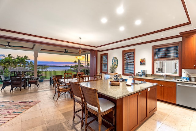 69-1000 Kolea Kai Cir Unit 7E, Waikoloa, HI 96738 - kitchen featuring appliances with stainless steel finishes, a sink, a tray ceiling, a center island, and brown cabinetry