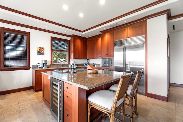 69-1000 Kolea Kai Cir Unit 7E, Waikoloa, HI 96738 - kitchen with built in appliances, beverage cooler, baseboards, stone countertops, and a kitchen island