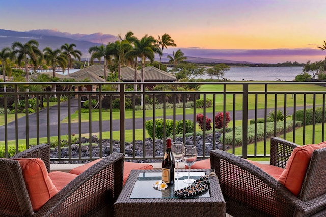 69-1000 Kolea Kai Cir Unit 7E, Waikoloa, HI 96738 - balcony at dusk featuring a water view