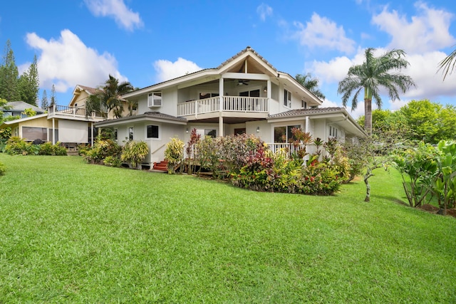 4194 Waileia Pl, Princeville, HI 96722 - rear view of house featuring a balcony, ceiling fan, a lawn, and stucco siding