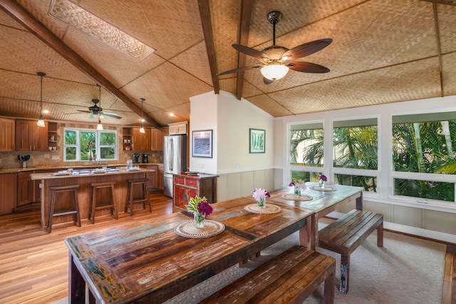 4194 Waileia Pl, Princeville, HI 96722 - dining area with ceiling fan, light wood-style flooring, wainscoting, and a skylight