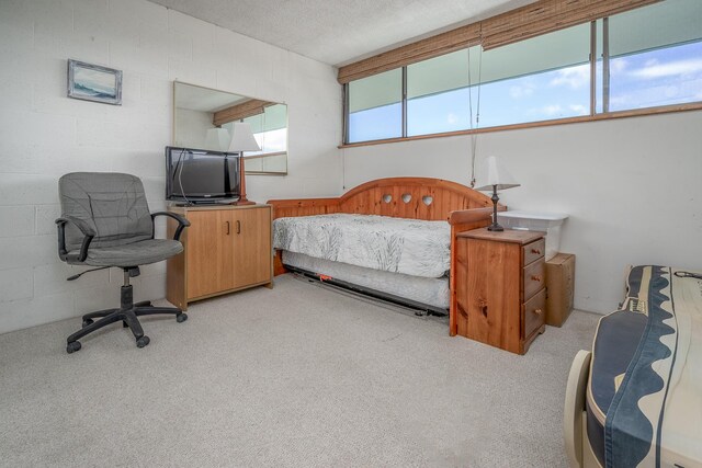 1875 Kalanianaole Ave Unit 409, Hilo, HI 96720 - bedroom featuring light colored carpet and concrete block wall