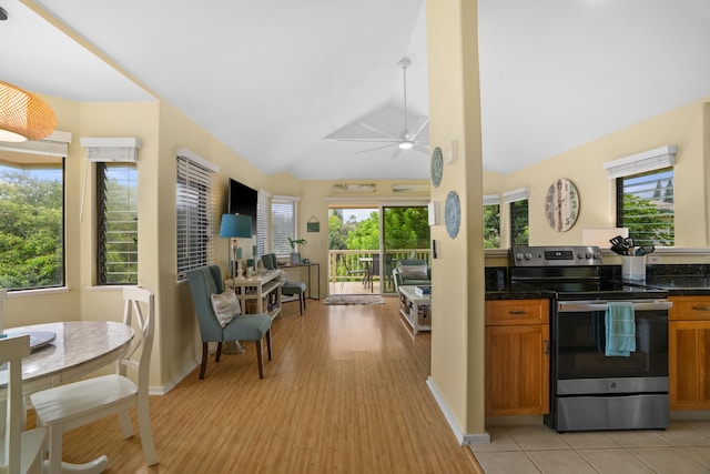 5451 Ka Haku Rd Unit 24, Princeville, HI 96722 - kitchen featuring electric range, dark countertops, brown cabinetry, a ceiling fan, and lofted ceiling