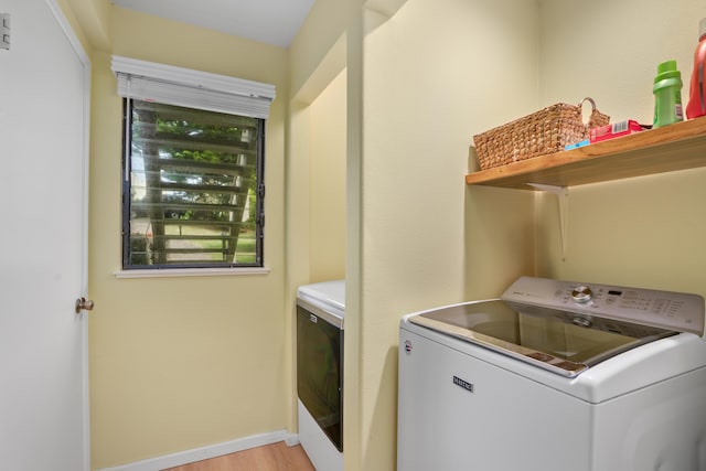 5451 Ka Haku Rd Unit 24, Princeville, HI 96722 - washroom with washer / clothes dryer, light wood-type flooring, and baseboards