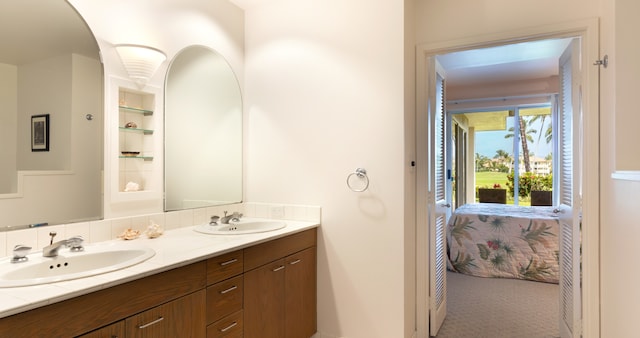 69-1010 Keana Pl Unit F105, Waikoloa, HI 96738 - full bathroom featuring double vanity, connected bathroom, and built in shelves