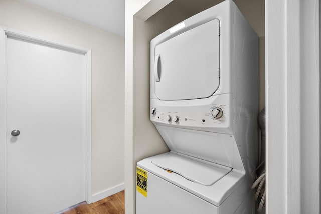 77-305 Kalani Way Unit 6, Kailua-Kona, HI 96740 - laundry room with stacked washing machine and dryer, light wood-type flooring, and baseboards
