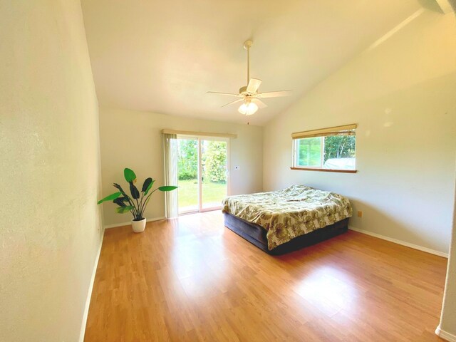 15-1676 6th Ave, Keaau, HI 96749 - bedroom with access to outside, multiple windows, wood finished floors, baseboards, and high vaulted ceiling