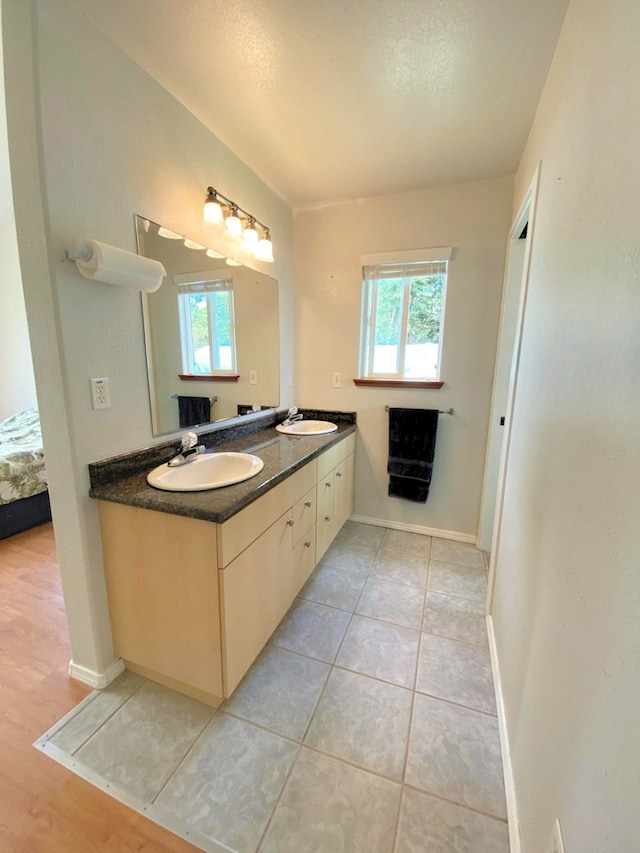 15-1676 6th Ave, Keaau, HI 96749 - ensuite bathroom with double vanity, tile patterned flooring, and baseboards