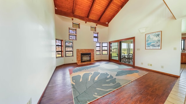 5370 Kaehulua Rd, Kapaa, HI 96746 - unfurnished living room featuring wood finished floors, wooden ceiling with exposed beams, high vaulted ceiling, a glass covered fireplace, and baseboards
