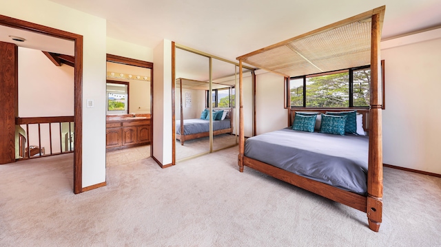 5370 Kaehulua Rd, Kapaa, HI 96746 - bedroom featuring light colored carpet, multiple windows, a sink, and a closet