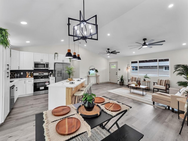 16-2112 Tangerine Dr, Pahoa, HI 96778 - dining area with lofted ceiling, a ceiling fan, recessed lighting, light wood-style floors, and a chandelier