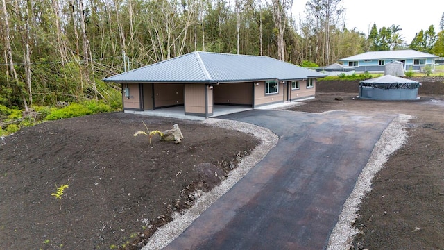 16-2112 Tangerine Dr, Pahoa, HI 96778 - view of front of property with metal roof and asphalt driveway