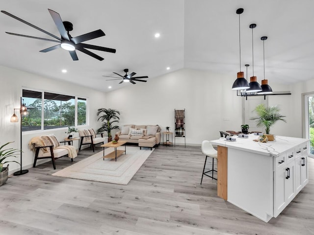 16-2112 Tangerine Dr, Pahoa, HI 96778 - living room featuring vaulted ceiling, ceiling fan, recessed lighting, light wood-style flooring, and baseboards