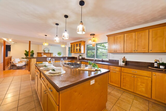 15-1506 23rd Ave, Keaau, HI 96749 - kitchen featuring light tile patterned floors, brown cabinetry, a kitchen island, and pendant lighting