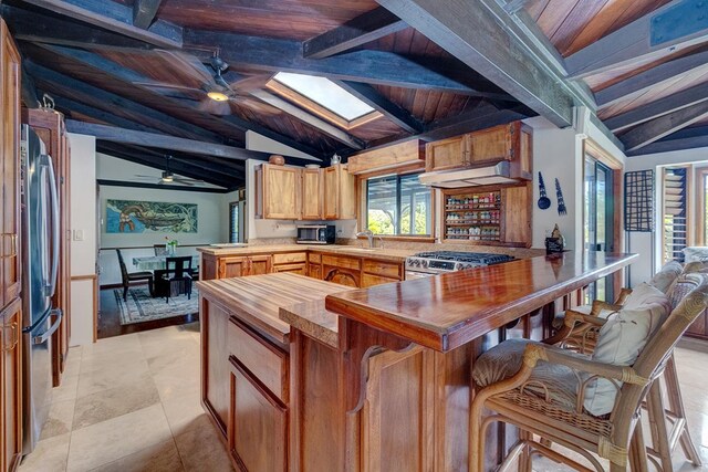 13-125 Nalu Pl, Pahoa, HI 96778 - kitchen featuring wooden counters, appliances with stainless steel finishes, a sink, a peninsula, and a skylight