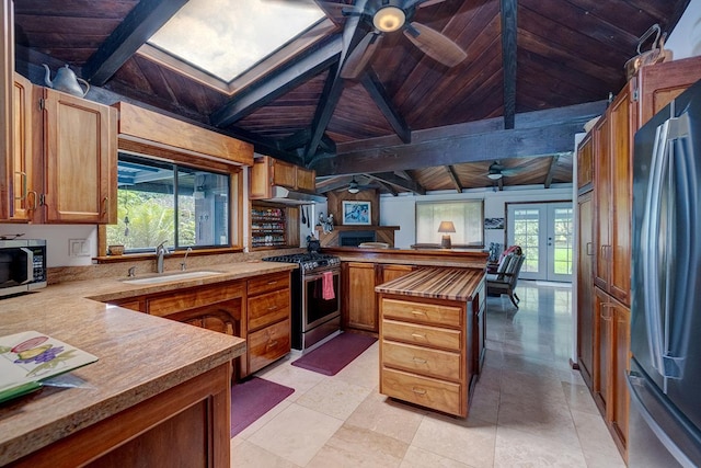 13-125 Nalu Pl, Pahoa, HI 96778 - kitchen featuring appliances with stainless steel finishes, a sink, wood ceiling with exposed beams, a peninsula, and a ceiling fan