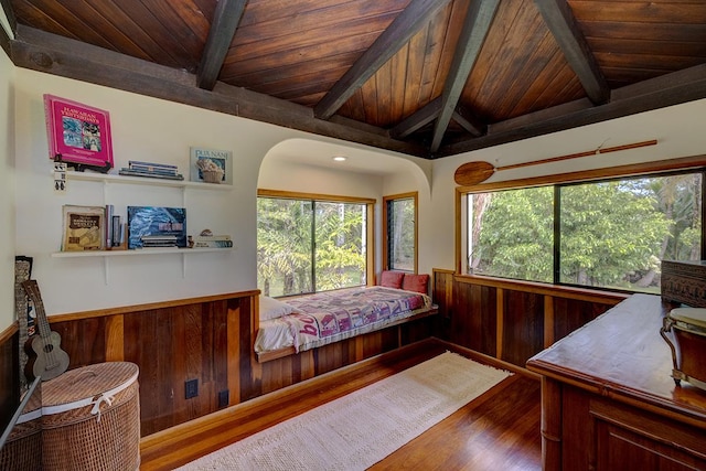 13-125 Nalu Pl, Pahoa, HI 96778 - bedroom with wood finished floors, multiple windows, wooden ceiling with exposed beams, a wainscoted wall, and arched walkways