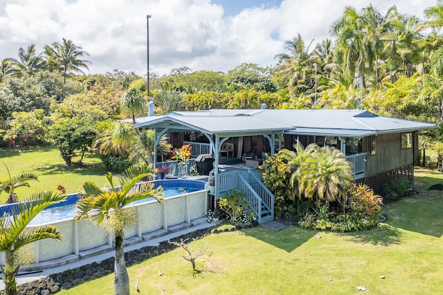 13-125 Nalu Pl, Pahoa, HI 96778 - view of front of property featuring a front lawn, an outdoor pool, and covered porch