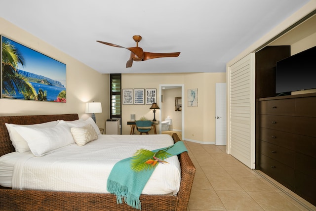 5454 Ka Haku Rd Unit 307, Princeville, HI 96722 - bedroom with light tile patterned floors, a closet, ceiling fan, and baseboards
