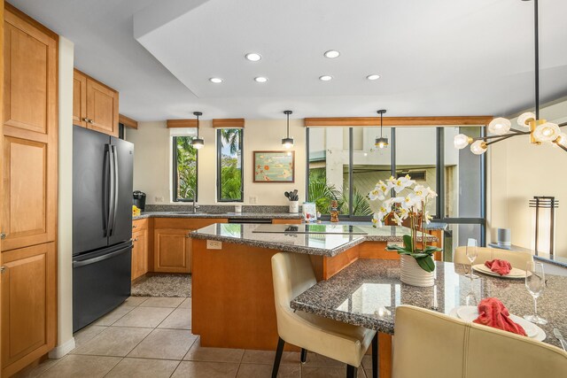 5454 Ka Haku Rd Unit 307, Princeville, HI 96722 - kitchen with freestanding refrigerator, recessed lighting, a sink, a breakfast bar area, and black electric stovetop