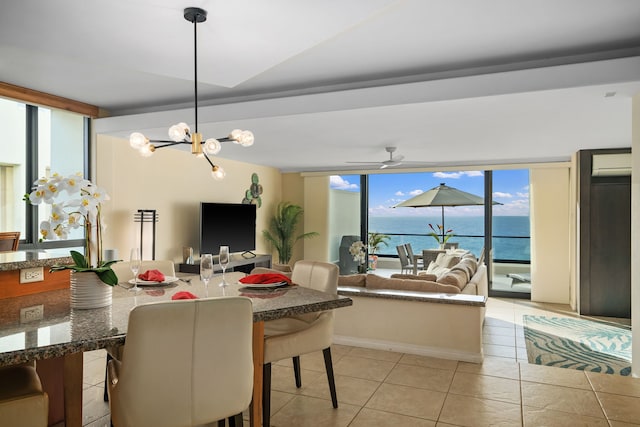 5454 Ka Haku Rd Unit 307, Princeville, HI 96722 - dining area with light tile patterned floors, expansive windows, and a chandelier