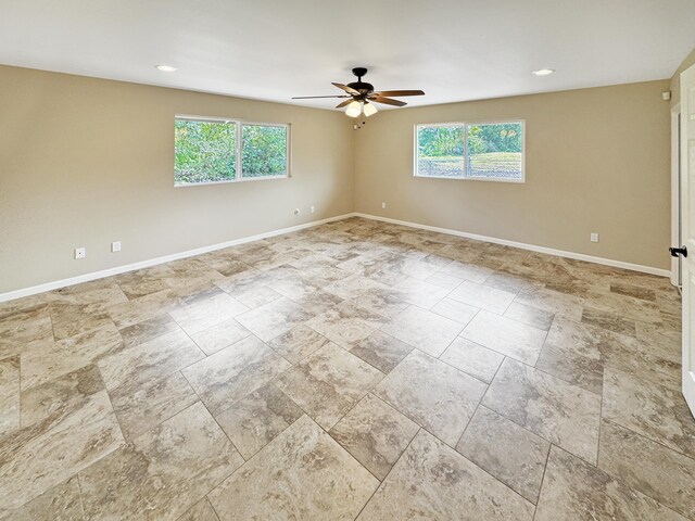 15-1580 17th Ave, Keaau, HI 96749 - unfurnished room featuring a ceiling fan, baseboards, stone finish flooring, and recessed lighting
