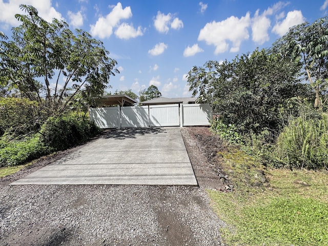 15-1580 17th Ave, Keaau, HI 96749 - view of front facade with a gate and driveway
