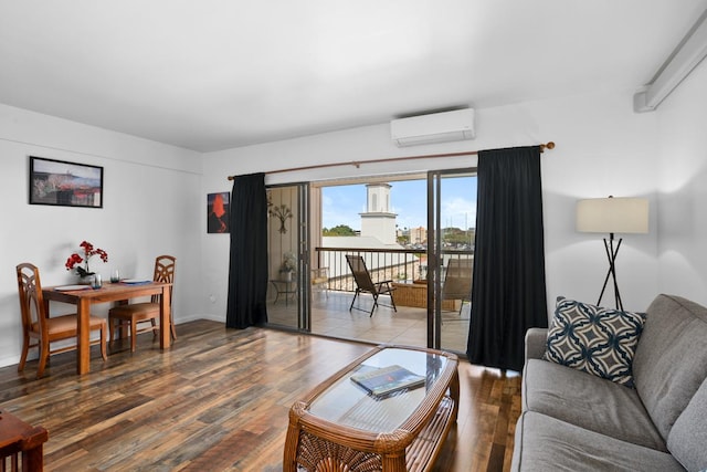 75-5719 Alii Dr Unit 414, Kailua-Kona, HI 96740 - living room with a wall mounted AC, wood finished floors, and baseboards