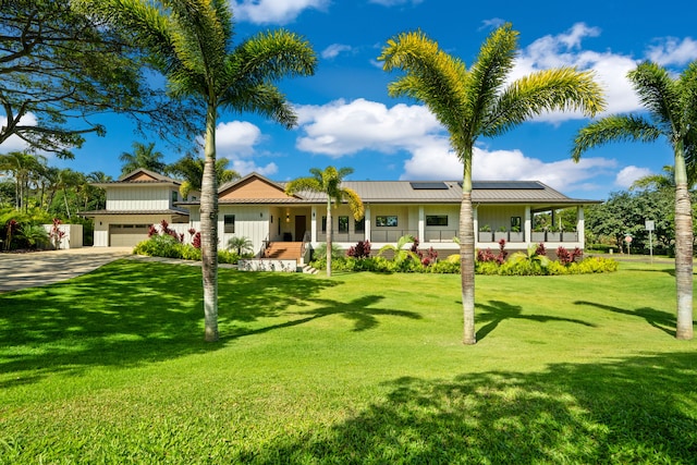2977 Pua Alani Pl, Koloa, HI 96756 - view of front of home with a porch, solar panels, and a front lawn
