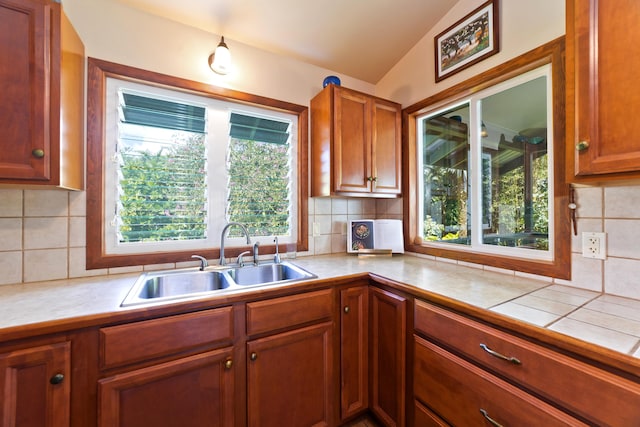 15-2021 11th Ave, Keaau, HI 96749 - kitchen featuring a sink, backsplash, brown cabinets, and lofted ceiling
