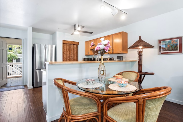76-134 Heenalu Rd Unit 10, Kailua-Kona, HI 96740 - dining area with track lighting, a ceiling fan, dark wood-type flooring, and baseboards