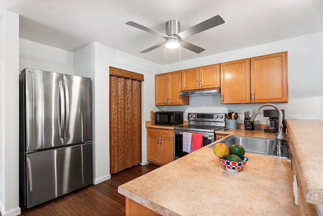76-134 Heenalu Rd Unit 10, Kailua-Kona, HI 96740 - kitchen with appliances with stainless steel finishes, under cabinet range hood, a sink, baseboards, and light countertops