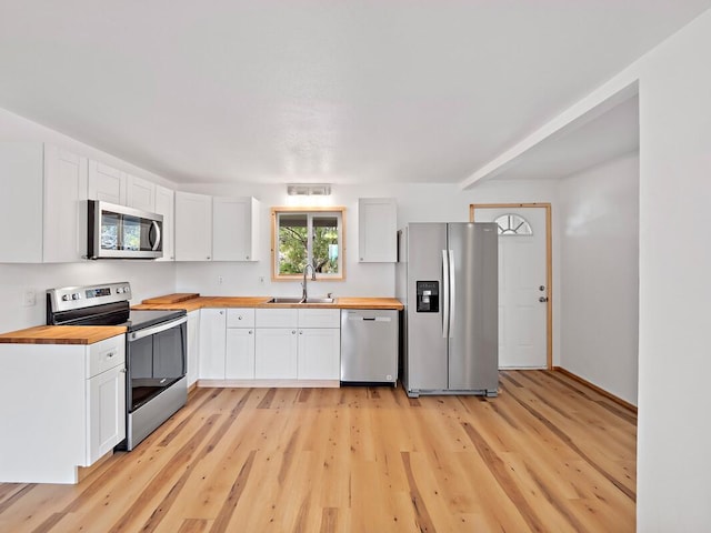 92-8215 Bamboo Ln, Ocean View, HI 96737 - kitchen with stainless steel appliances, wooden counters, a sink, and light wood-type flooring