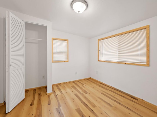 92-8215 Bamboo Ln, Ocean View, HI 96737 - unfurnished bedroom with wood finished floors, baseboards, and a closet