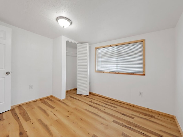 92-8215 Bamboo Ln, Ocean View, HI 96737 - unfurnished bedroom featuring wood finished floors, a closet, and baseboards