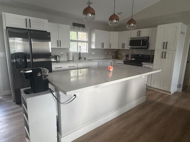 16-2062 Paradise Dr, Pahoa, HI 96778 - kitchen with stainless steel appliances, a sink, white cabinetry, wood finished floors, and a center island