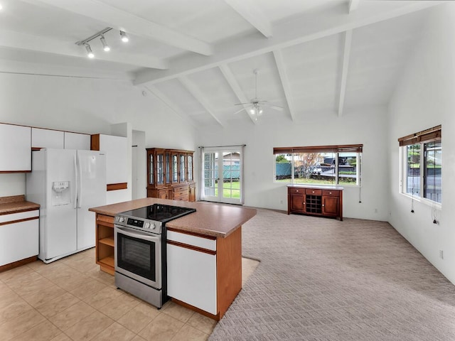 907 Mala Pua Way, Hilo, HI 96720 - kitchen featuring white refrigerator with ice dispenser, stainless steel electric range, ceiling fan, plenty of natural light, and beam ceiling