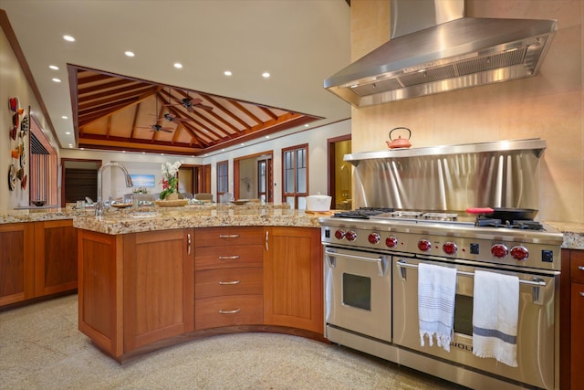 68-108 Pukaua Pl, Kamuela, HI 96743 - kitchen with wall chimney range hood, double oven range, lofted ceiling, brown cabinets, and ceiling fan