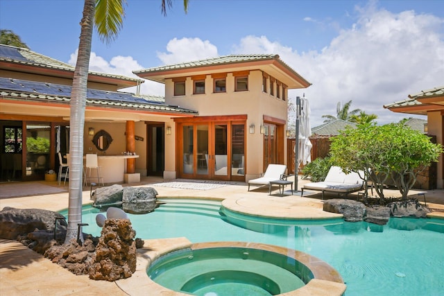 68-108 Pukaua Pl, Kamuela, HI 96743 - back of property with a patio area, a tiled roof, a pool with connected hot tub, and stucco siding