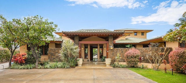 68-108 Pukaua Pl, Kamuela, HI 96743 - view of front facade featuring a tile roof, stucco siding, and stone siding