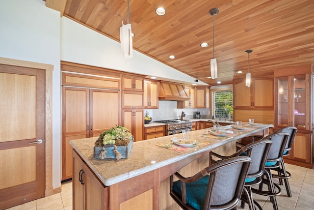 7312 Alealea Rd, Hanalei, HI 96722 - kitchen with premium range hood, wooden ceiling, range with two ovens, vaulted ceiling, and light tile patterned flooring