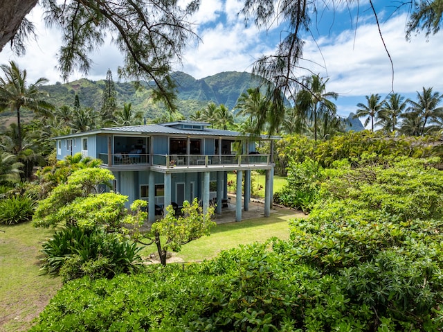 7312 Alealea Rd, Hanalei, HI 96722 - back of house featuring a yard, a mountain view, and a balcony