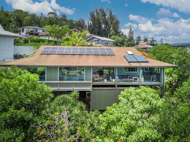 4282 Kalaheo Dr, Kalaheo, HI 96741 - back of property with roof mounted solar panels, a shingled roof, and a balcony