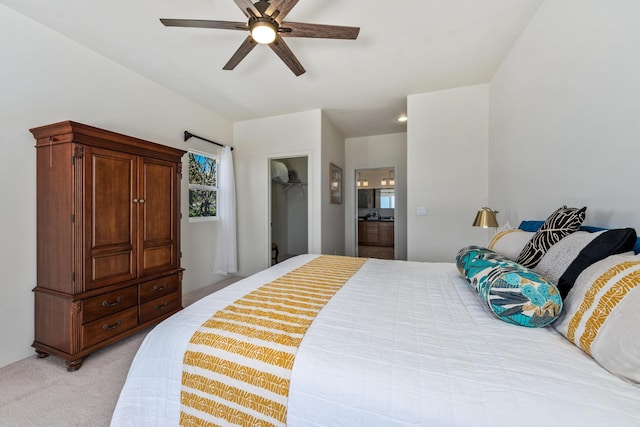 68-1634 Laie St, Waikoloa, HI 96738 - bedroom with light carpet, connected bathroom, a spacious closet, and a ceiling fan
