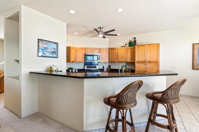 68-1634 Laie St, Waikoloa, HI 96738 - kitchen featuring stainless steel appliances, recessed lighting, ceiling fan, a kitchen bar, and a peninsula