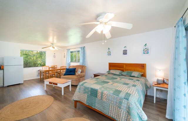 15-1893 32nd Ave, Keaau, HI 96749 - bedroom featuring freestanding refrigerator, wood finished floors, and ceiling fan