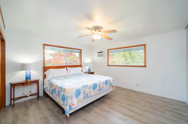 15-1893 32nd Ave, Keaau, HI 96749 - bedroom featuring multiple windows, wood finished floors, and ceiling fan