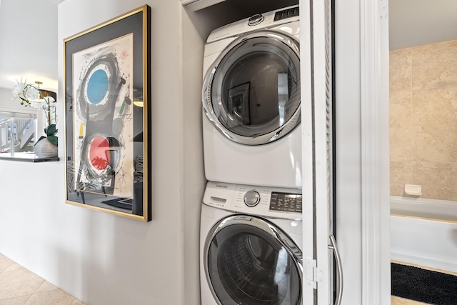 75-6081 Alii Dr Unit Ff102, Kailua-Kona, HI 96740 - laundry area featuring stacked washing machine and dryer and tile patterned flooring