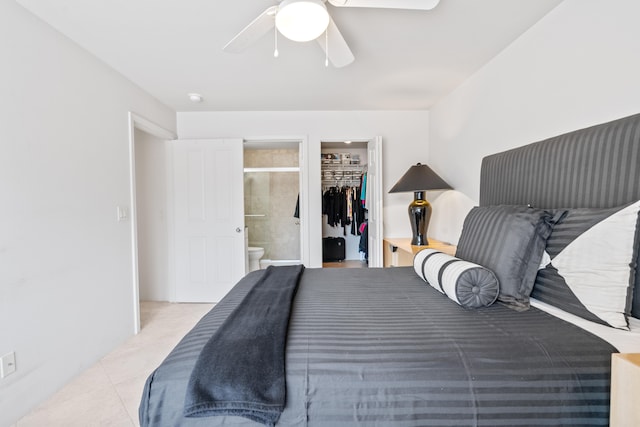 75-6081 Alii Dr Unit Ff102, Kailua-Kona, HI 96740 - bedroom featuring a walk in closet, ensuite bath, a closet, a ceiling fan, and tile patterned floors